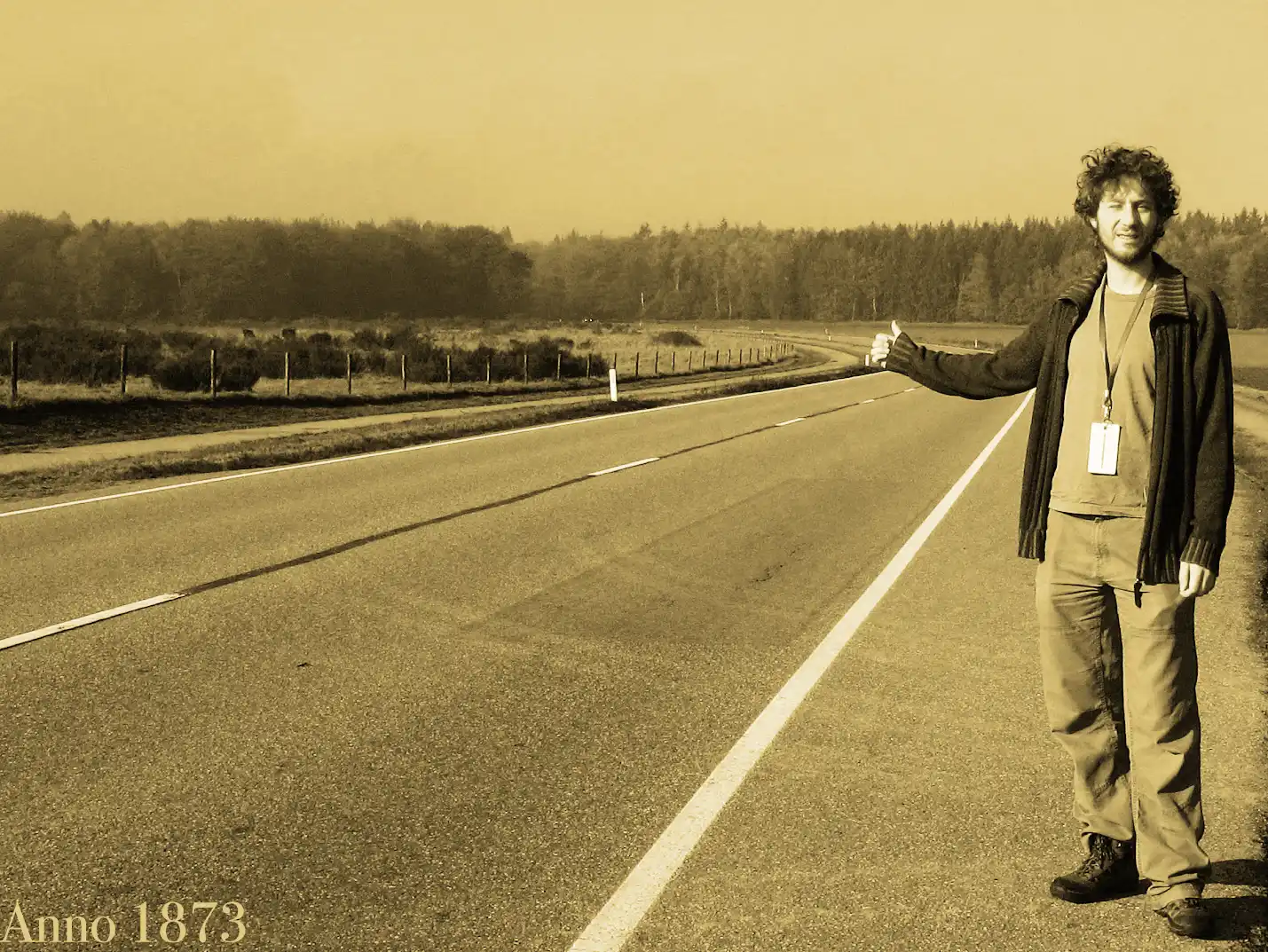 David hitchhiking on a road